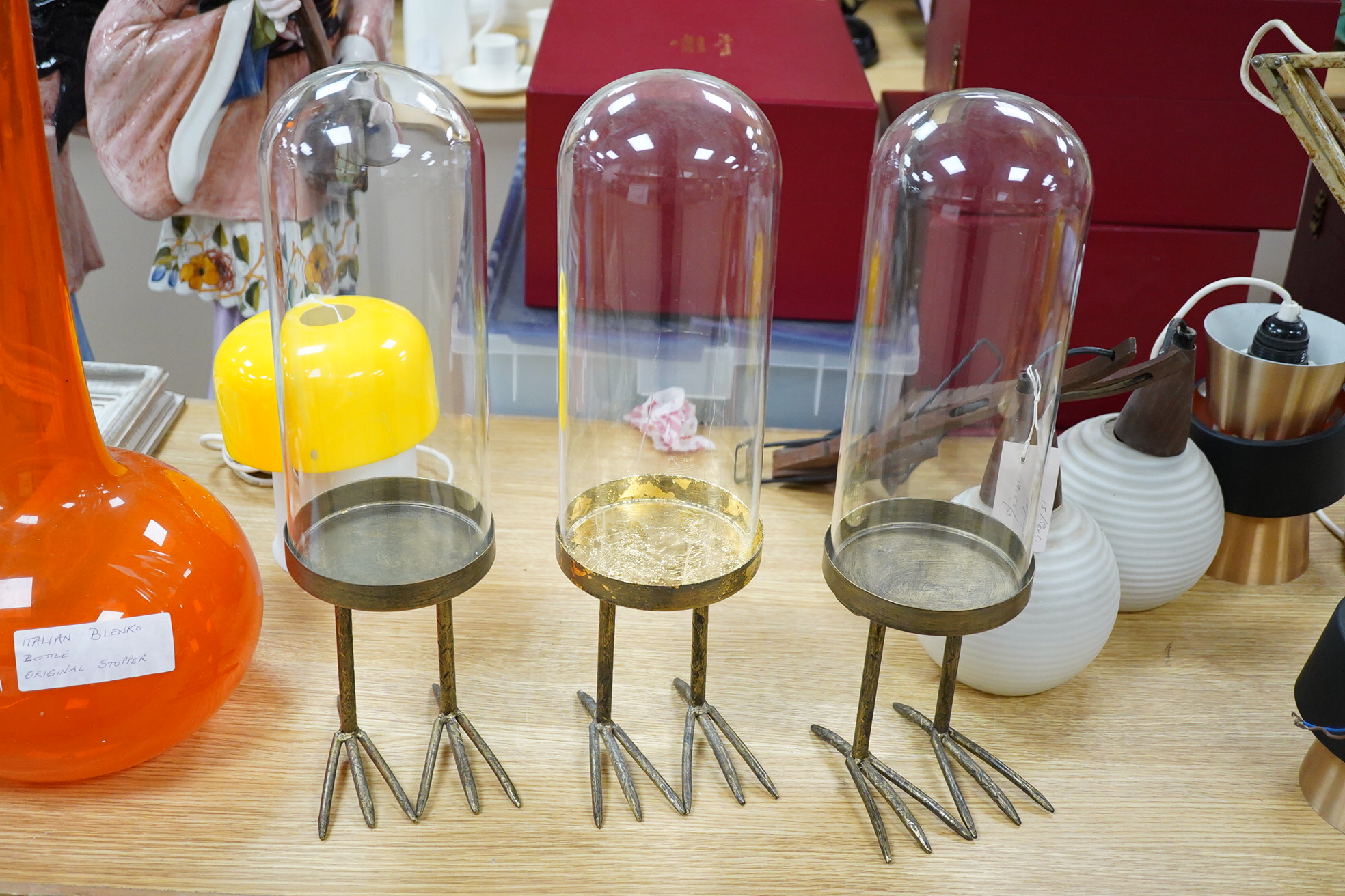 A trio of unusual glass domed display cases on ‘birds feet’ stands, 45cm